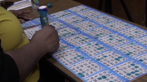 A woman checks off bingo cards